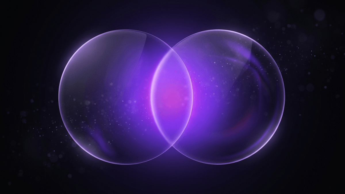 Two overlapping glass circles whose violet intersection glows brightest