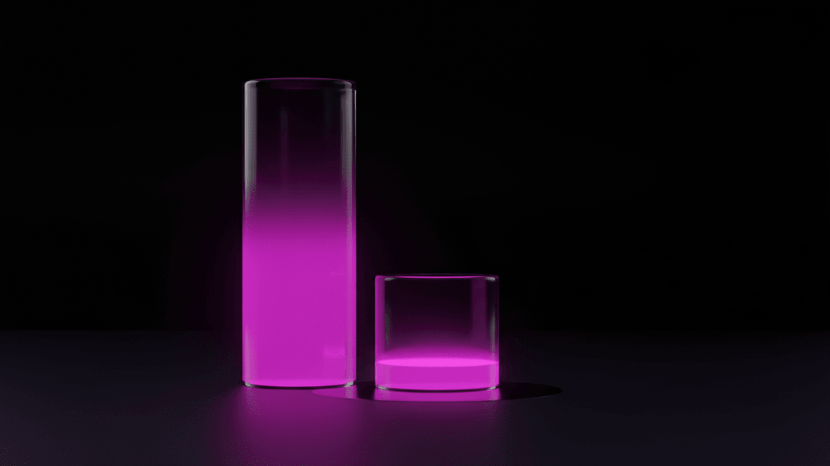 A tall glass column filled nearly to the top with light beside a short, almost empty one
