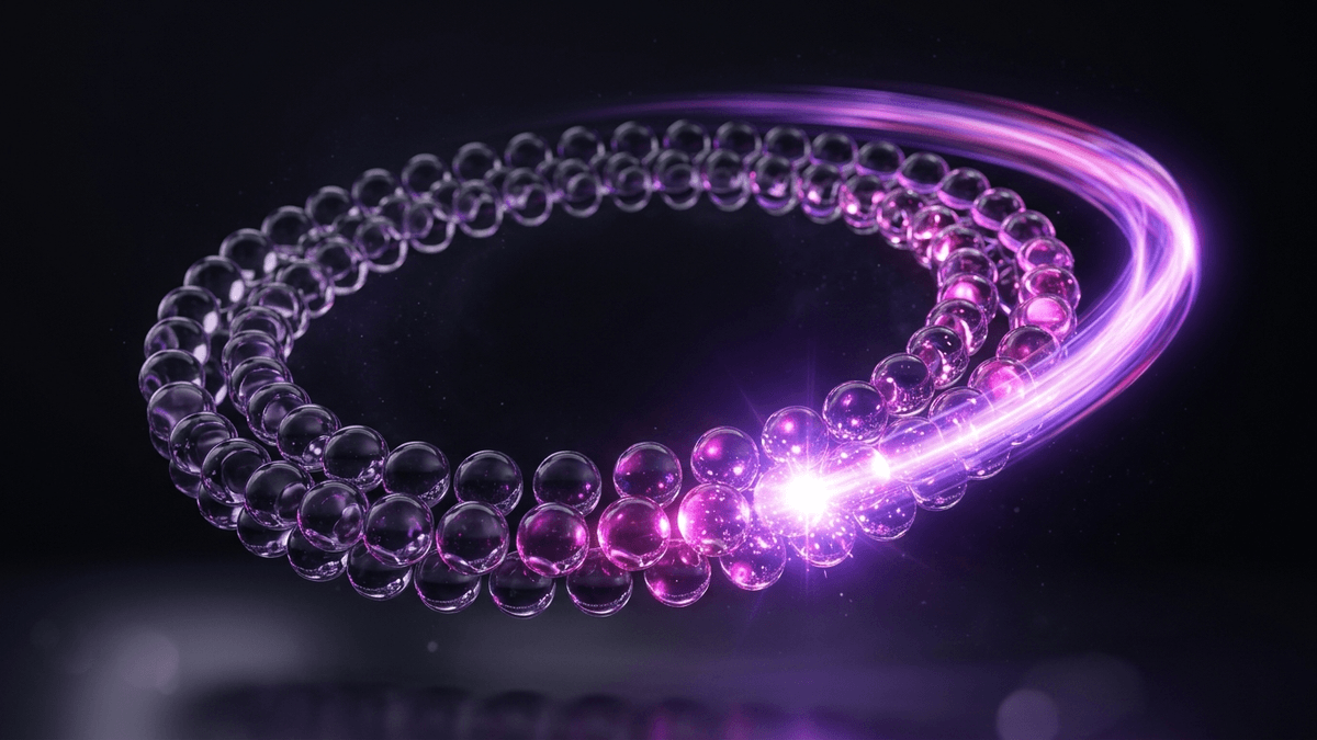 A ring of glass spheres circling a dark centre with light chasing around the loop