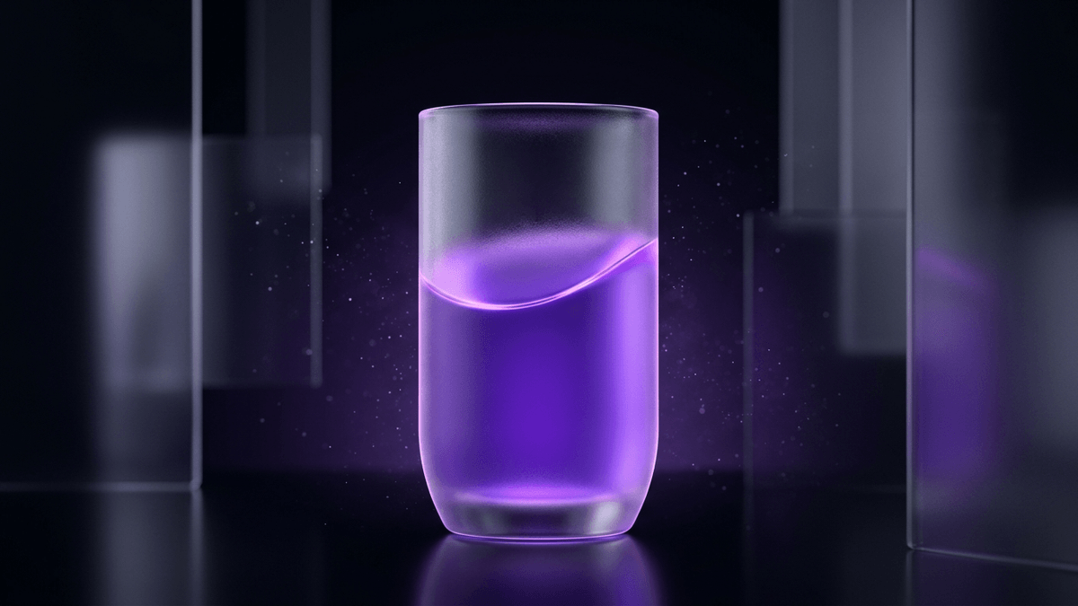 A partially filled frosted glass vessel with a violet meniscus and empty space above