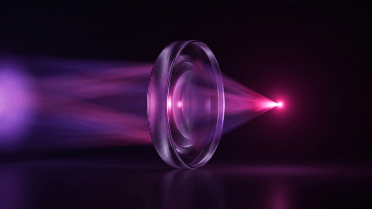 A glass lens gathering scattered light into one concentrated burning point