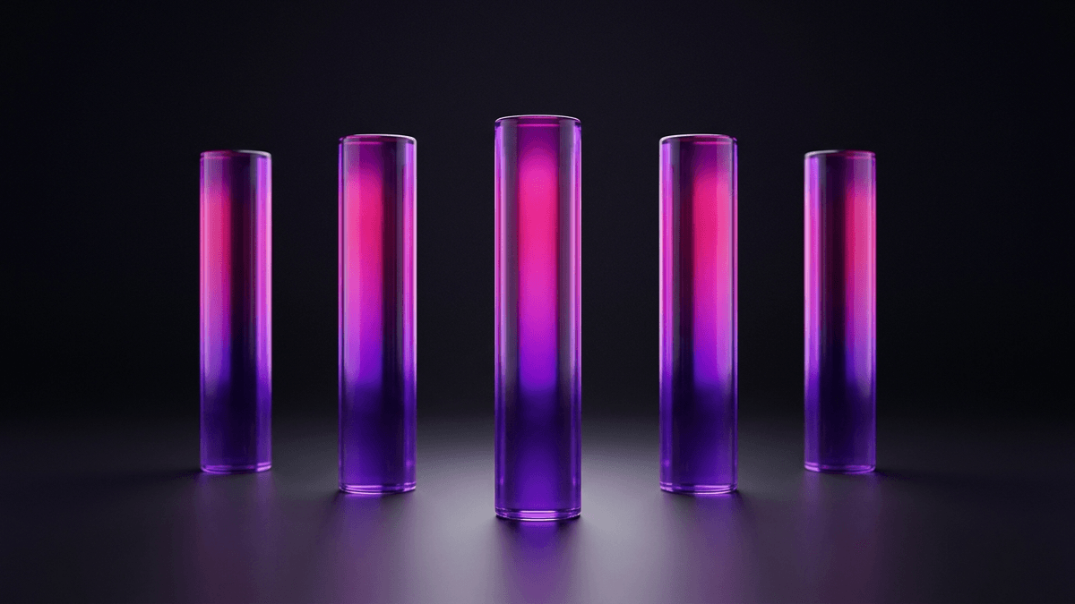 Five glass pillars set in deliberate formation on a lit stage floor