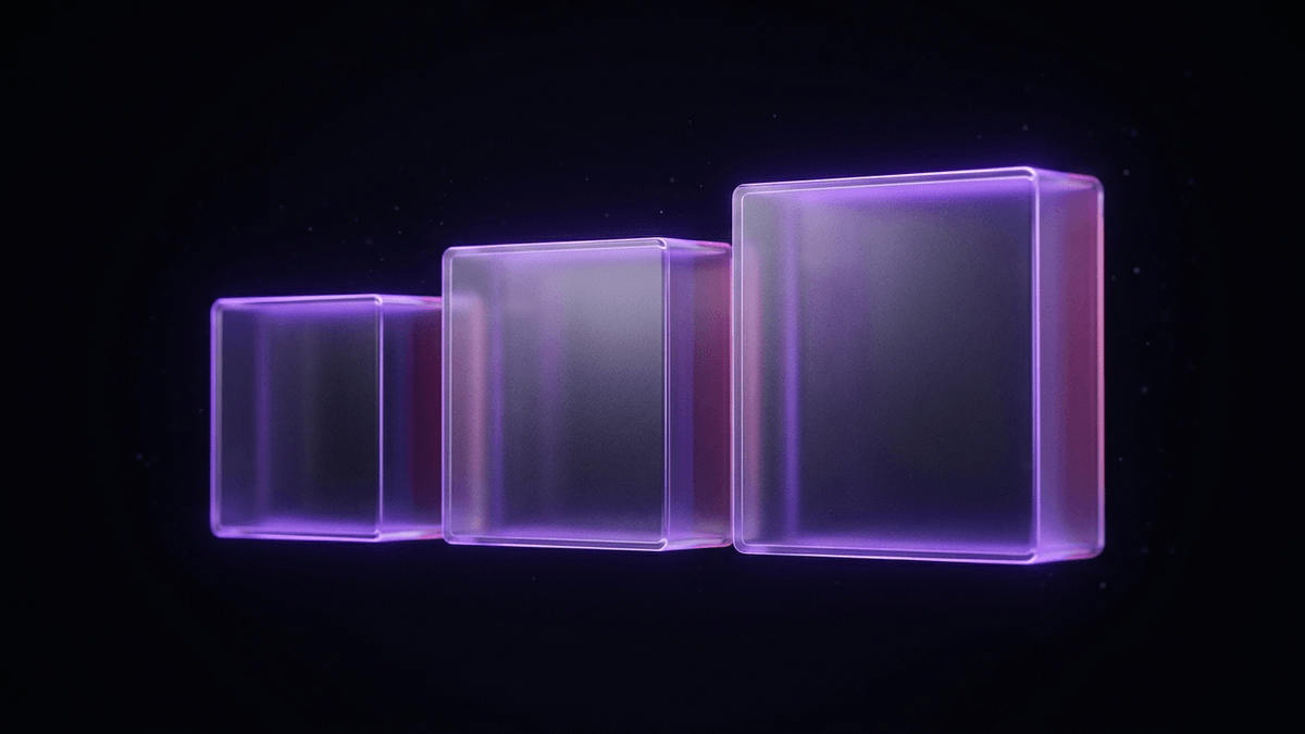 Three translucent glass blocks of graduated size arranged in a row, violet rim light